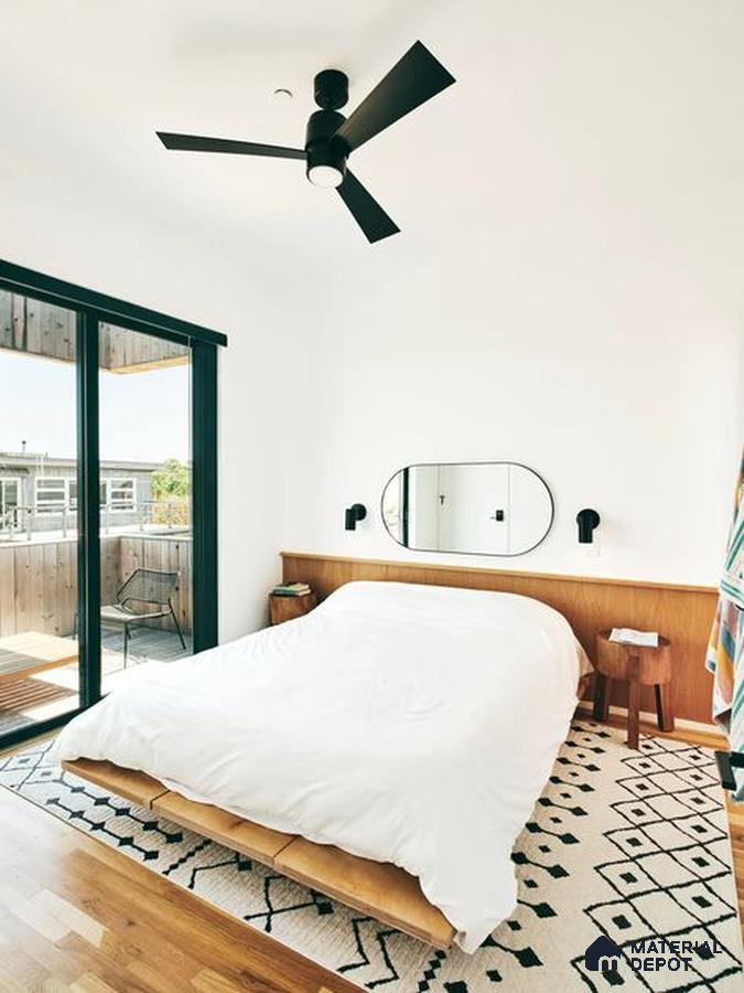 A room filled with lots of windows and a plant in the corner next to it on the floor of a stair case next to a wall mounted to a wall mounted to a window sill of a window